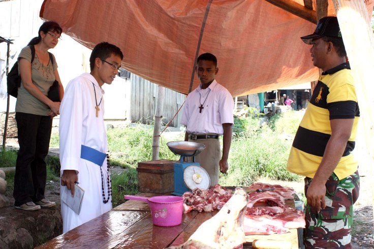 Buying pork at the local markets for children's feeding programme (27 October 2010)
