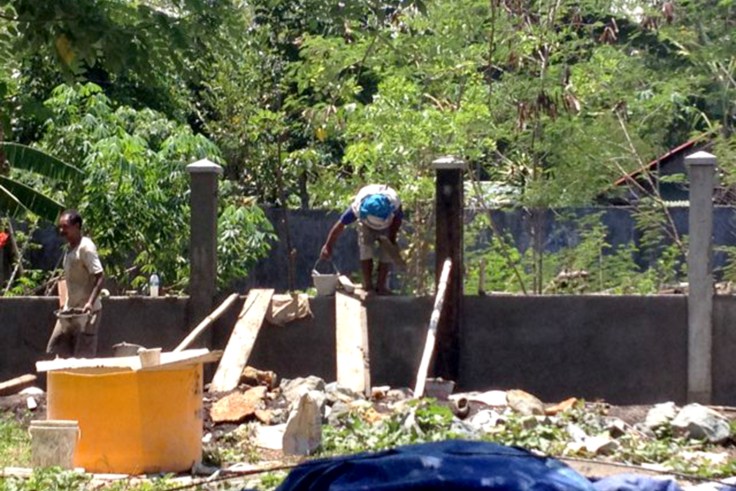 Locals working hard to finish the fence around the apostolate inside the monastery grounds