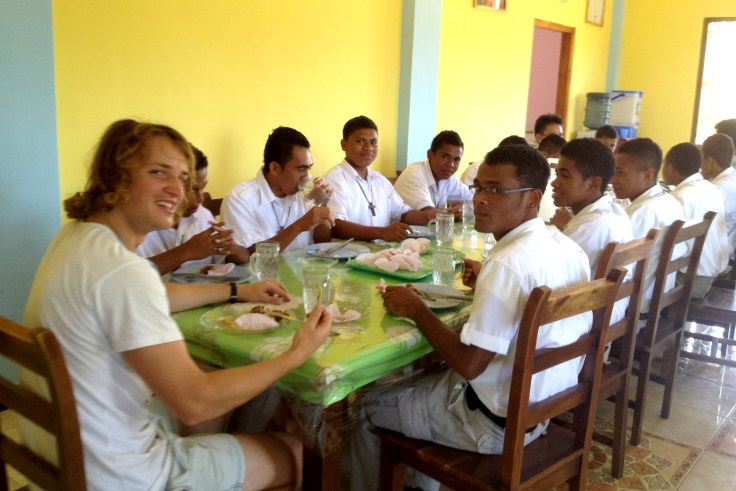 Matthew eating with the brothers…. He is about to try a hot chilli!