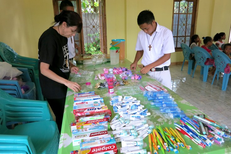Preparing the give-aways, including hair bands for the girls