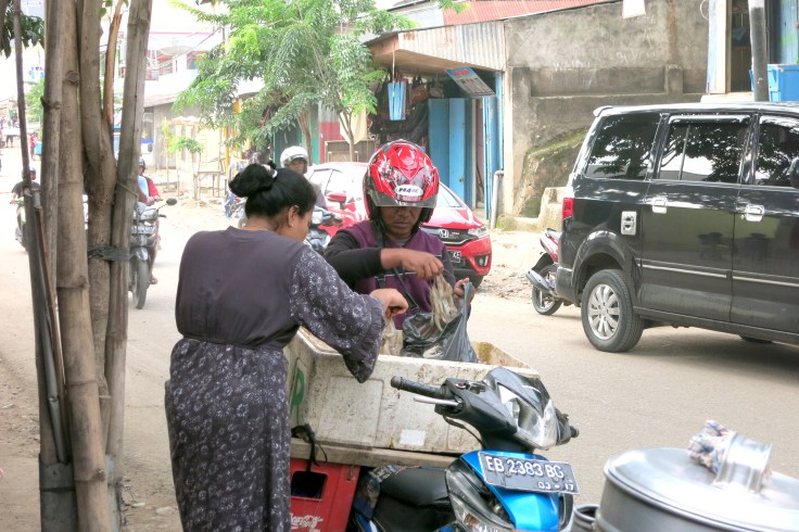 12. Some seafood sold from the back of a motorcycle