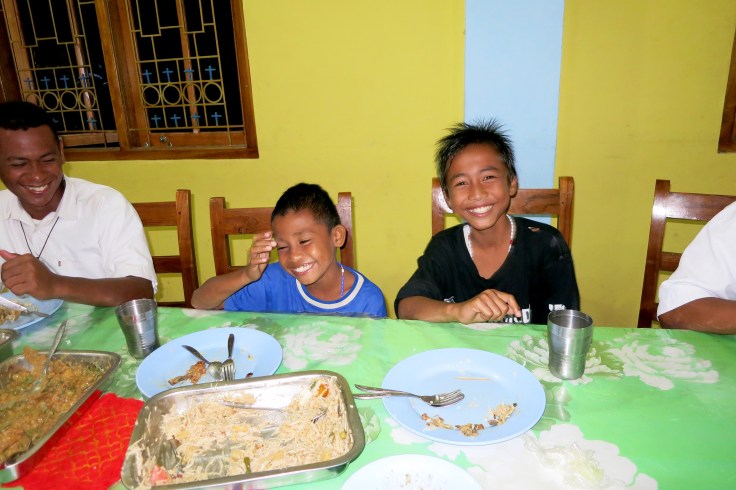 25. Sponsor child Devonne on right with Angel on left having dinner with the brothers