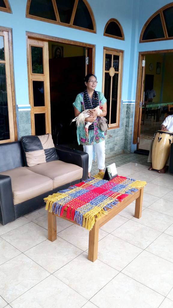Traditional Indonesian greeting, Michele receives a chicken as a gift