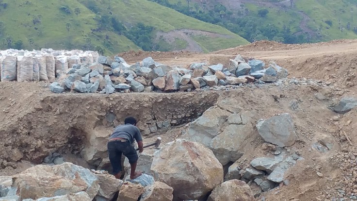 The people earn very little by selling bags of stones