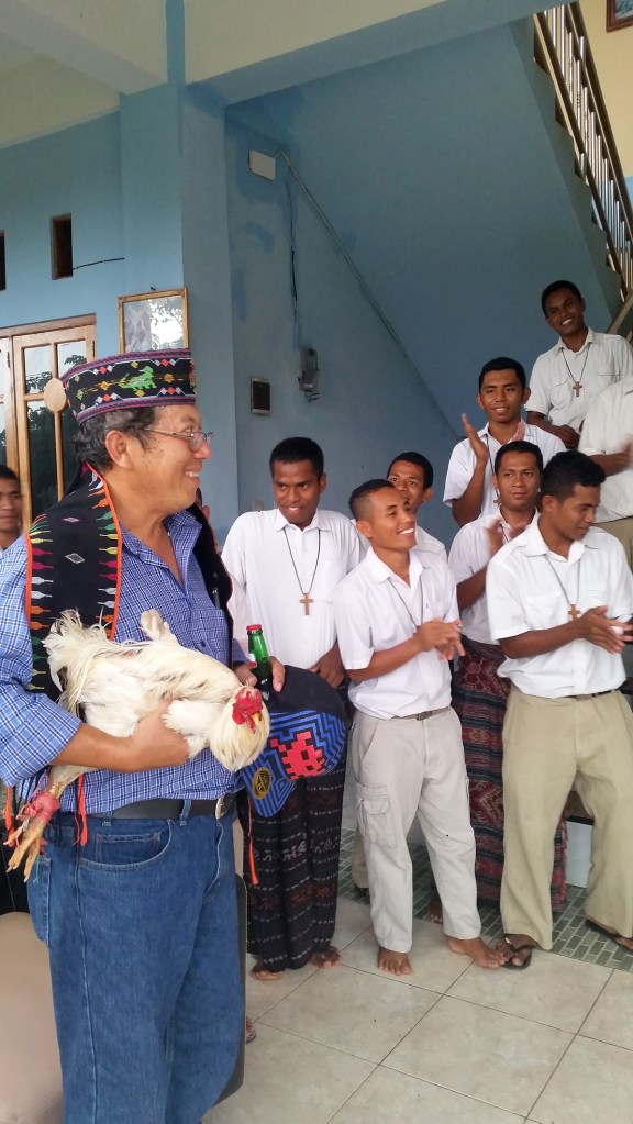 Heru also receiving the customary greeting with a chicken