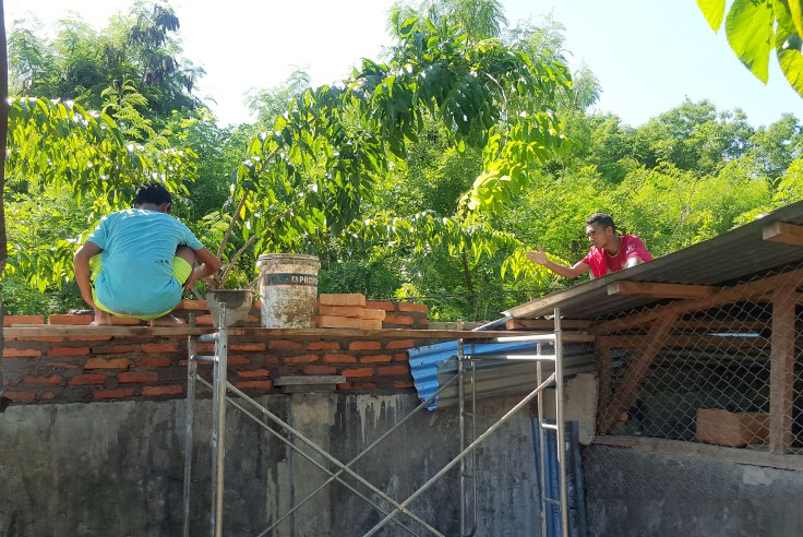 16. The brothers turning their hands to brick laying