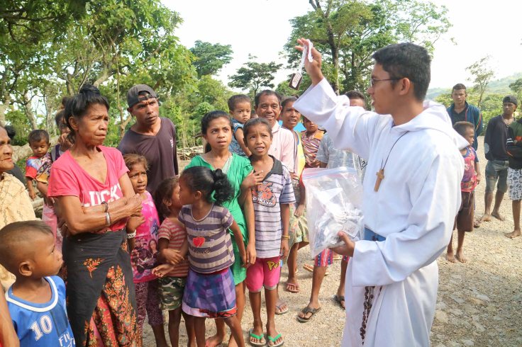 6. Brother starts distributing the scapulars
